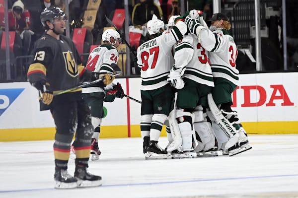 Wild players celebrate their overtime victory over the Golden Knights in Game 1 of their playoff series Sunday in Las Vegas.