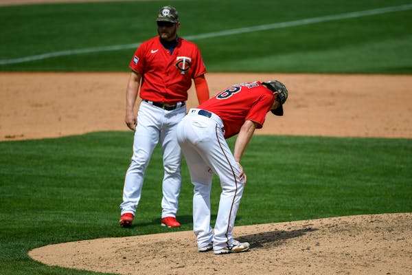 Minnesota Twins pitcher Kenta Maeda, right, takes a moment after giving up a hit in the fifth inning Sunday.