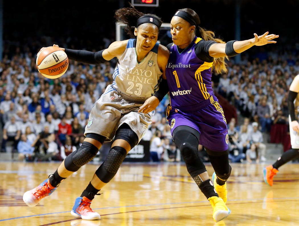 Maya Moore, left, drives around Los Angeles Sparks’ Odyssey Sims during Game 5 of the WNBA finals at Williams Arena in 2017.