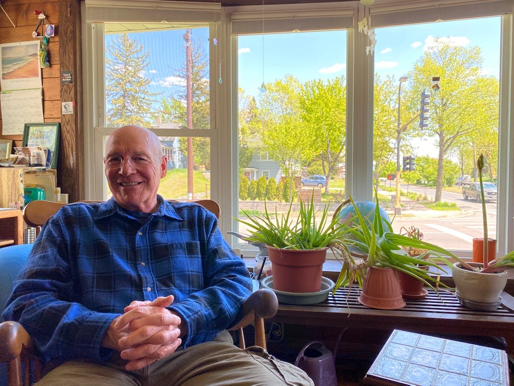Roy Vanderwerf sitting in his sun room. The new cellular pole visible in the background.