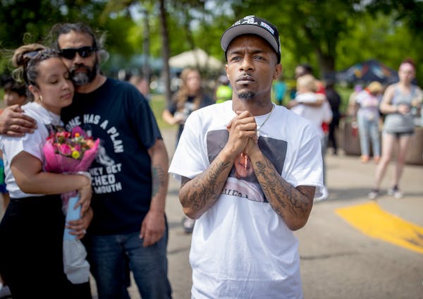 Raishan Smith, the father of 9-year-old Trinity Ottoson-Smith, looked to North Memorial Hospital to offer prayer for his daughter during a rally, Sund