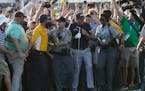 Phil Mickelson tries to move through the crowd on the 18th hole during the final round at the PGA Championship golf tournament on the Ocean Course, Su