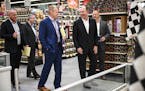 Hy-Vee CEO Randy Edeker, right of center, joked with Jeremy Gosch, president of retail operations, during a walk-through of the new Spring Lake Park l