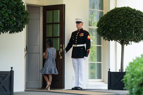A Marine held the door as Gianna Floyd, the daughter of George Floyd, walked into the White House on Tuesday.