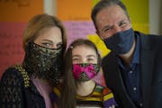 Stephanie and Cory Lake with their daughter, Odette, 7, in their Minnetonka home. “We will continue to wear masks in any indoor setting,” Stephani