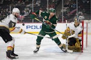 Minnesota Wild left wing Marcus Foligno tried to deflect a pass from the corner while defended by Vegas Golden Knights defenseman Alex Pietrangelo in 