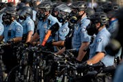 Police gather en masse as protests continue at the Minneapolis 3rd Police Precinct, Wednesday, May 27, 2020, in Minneapolis. 