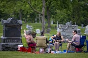 Laura and Jeff Soderquist, left, and Sally and Scott Taylor, right, met for a picnic at Lakewood Cemetery, Sunday, May 23, 2021 in Minneapolis, MN.  T