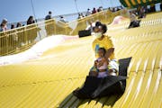 Shawnda Henderson of Minneapolis rode the Giant Slide with her daughter Mira on the last day of the Kickoff to Summer at the Fair event at the Minneso