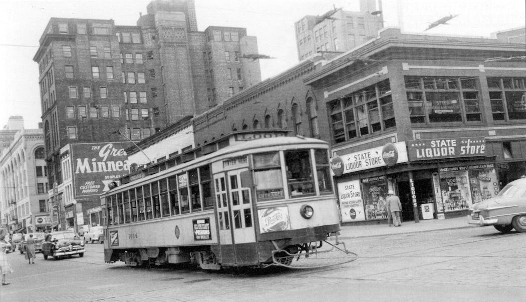 A streetcar with a 'Loop' destination sign travels downtown in 1953.