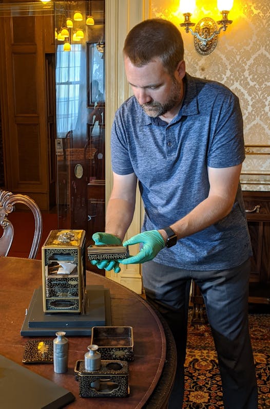 Glensheen Mansion director Dan Hartman demonstrates how a Japanese bento box works. The bento box is part of a new Glensheen exhibit called 