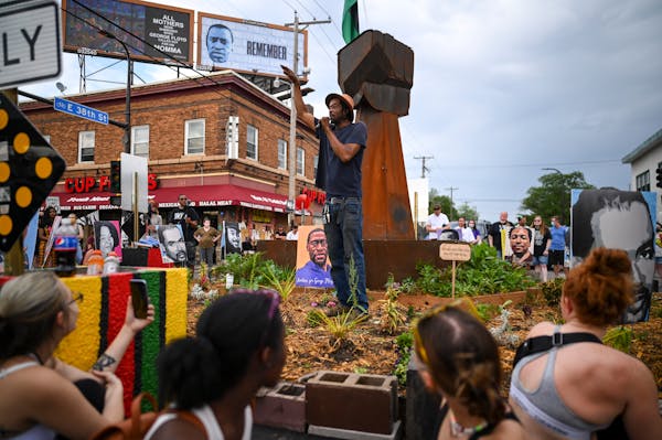 Jay Webb, a gardener and activist at George Floyd Square, spoke to a crowd of about 150 from the garden beneath the fist statue in the 38th and Chicag