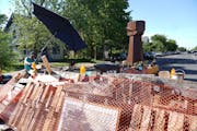 A new barricade and a new fist sculpture are at the south and north entrance to George Floyd Square a day after part of the square was cleared in Minn