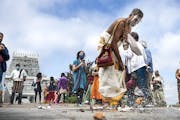 Narasimman Rengasamy smashed a coconut during a ritual honoring the Hindu figures of Vishnu and Garuda outside the Hindu Temple of Minnesota, which is