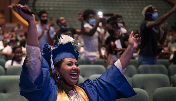 Rahma Yusuf valedictorian for the 2021 North Community High School celebrates as classmates are names are called to receive their diplomas . Jerry Hol
