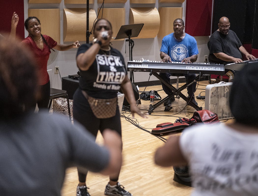 Jamecia Bennett left, Gary Hines and Billy Steele during rehearsal for performance at George Floyd Square.