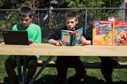 In Owatonna, Minn., the Hadt siblings, from left, Riley, 14, Carter, 11, and Abigail, 7, took advantage of the weather to read outside.