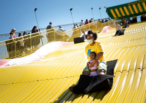 Shawnda Henderson, of Minneapolis, rode the Giant slide with her daughter Mira on the last day of the Kickoff to Summer at the Fair event in May at th