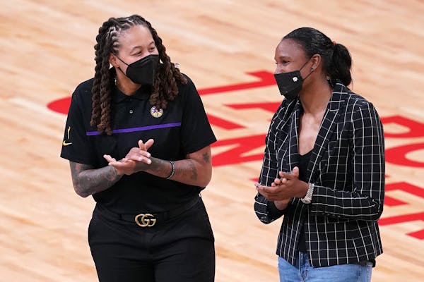 L.A. assistant coach and former Lynx star Seimone Augustus greeted fellow former Lynx star Rebekkah Brunson. Both will have their jerseys retired by t