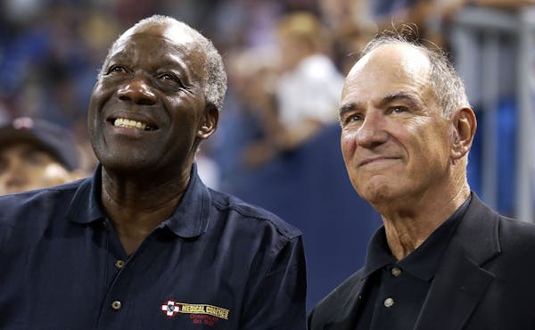 Former Twins’ pitcher Jim “Mudcat” Grant, left, and second baseman Frank Quilici watch highlights of their 1965 World Series team on the scorebo