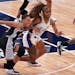 Aerial Powers of the Lynx and Los Angeles Sparks guard Te’a Cooper (2) raced for a loose ball Saturday.