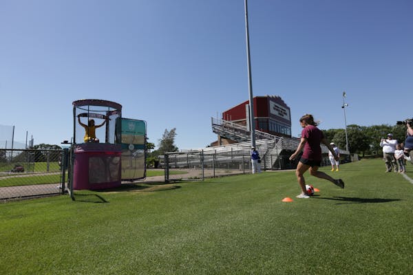 Former Gophers soccer player Maddie Castro shot to sink Andrea Yoch into the dunk tank at Elizabeth Lyle Robbie Stadium. On Sunday, Yoch was announced