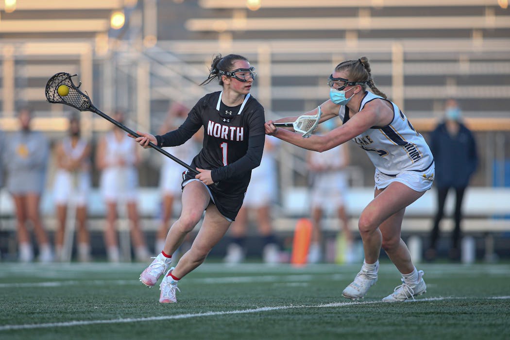 Prior Lake all-state player Payton Bloedow, right, pressured Lakeville North’s Alex Ward in an April game. Bloedow and the Lakers won the 2019 state tournament and are defending champions because the pandemic wiped out the 2020 tourney.