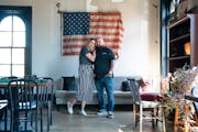 Hope Breakfast Bar owners Brian and Sarah Ingram, on a busy Tuesday morning. This flag, on display in the upstairs dining area, was found in the wall 