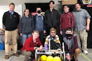 The Eagle Ridge Academy robotics team poses with the robot used in this year&#39;s competition season.