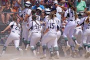 Rosemount’s Paige Zender (5) celebrated with her teammates as she crossed home plate after hitting a grand slam in the fifth inning of the Class 4A 