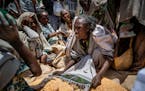 An Ethiopian woman argues with others over the allocation of yellow split peas after it was distributed by the Relief Society of Tigray in the town of