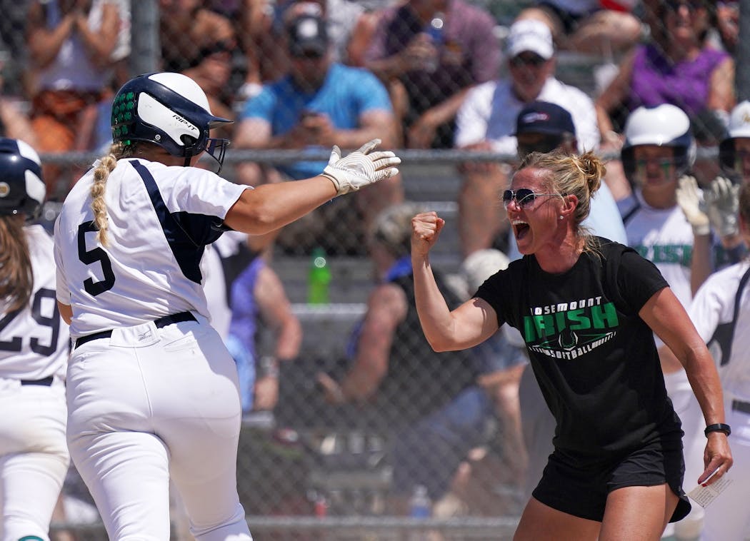 Rosemount’s Paige Zender (5) celebrated with head coach Tiffany Rose as she rounded third after hitting a grand slam in the fifth inning of the Class 4A championship game against Forest Lake last week.