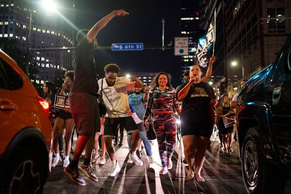 Protestors dance and chant down Third Avenue in downtown after the sentencing of former Minneapolis police officer Derek Chauvin on Friday, June 25, 2