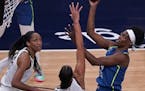 Sylvia Fowles shoots over Liz Camage during Friday night’s game.