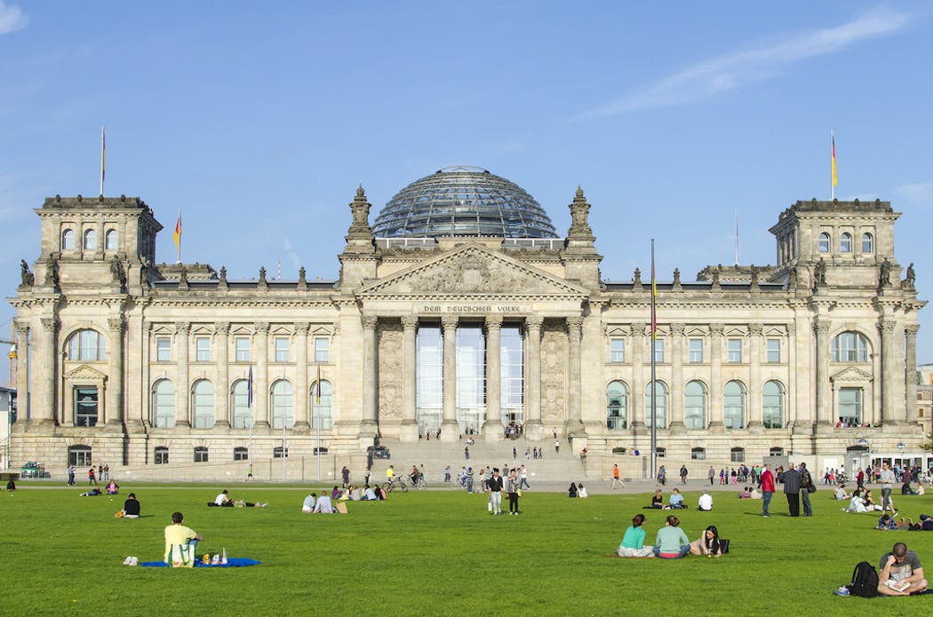 Tourists and residents gather near the iconic Reichstag Building in Berlin. Germany has reopened its borders to fully vaccinated leisure travelers from the U.S.