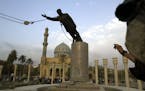 A U.S. Marine watched a statue of Saddam Hussein being toppled in in downtown Baghdad on April 9, 2003. “Two decades on,” writes Mortada Gzar, a n