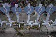 Associated Press/Rebecca Blackwell Wilted flowers and messages of love decorate a rain-soaked memorial Monday for the victims of the Champlain Towers 
