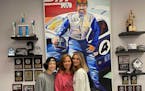 Ayden, Kristi and Alyssa Copham, in front of painting of their late husband & father Jed.