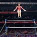 Suni Lee performing her signature move, the Nabieva, in the beginning of her uneven bars routine at the U.S. Olympic gymnastics team trials on June 27