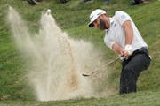 Dustin Johnson hit his second chip shot out of the bunker just off the ninth green at TPC Twin Cities on Friday. The world’s No. 2 golfer missed the