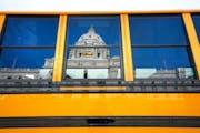 This file photo shows a school bus outside the Minnesota State Capitol in February 2020. More than 50 school board members in Minnesota have left thei