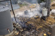 Salvage crews and volunteer firefighters cleaned up what was left of the grain elevator in Clinton, Minn., on Monday, July 26.