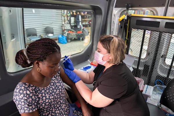 A health care worker administered a COVID-19 vaccine to Jacqueline Nikiena in New York, July 20, 2021.