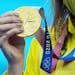 Australia’s Ariarne Titmus displays her gold medal after winning the women’s 200 meter freestyle finals 