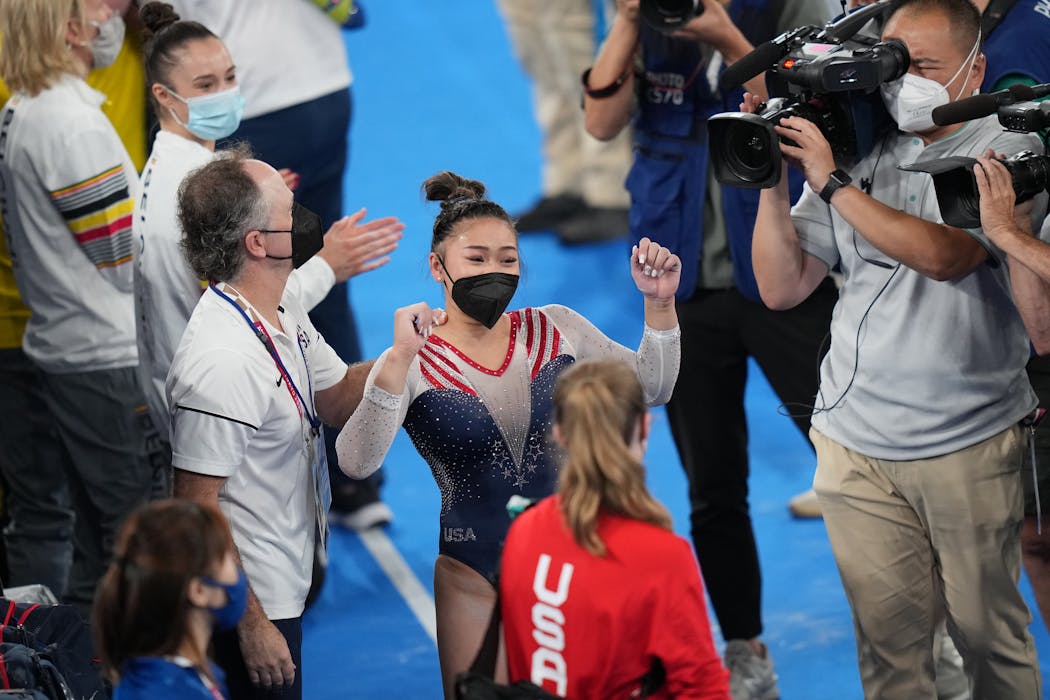 Suni Lee of the United States celebrates her gold medal.