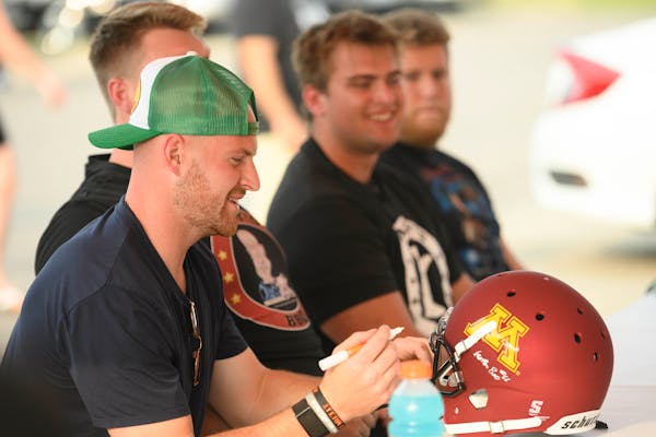 For $10 a pop, Tanner Morgan and his Gophers teammates signed autographs Wednesday at a Lakeville restaurant.