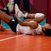 Jordan Thompson lies on the court after an injury during the women’s volleyball preliminary round pool B match between United States and Russian Oly