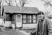 Gary Kirt, former owner of Bell Mortgage, is shown with a house he purchased for $6,500 when he was 17.