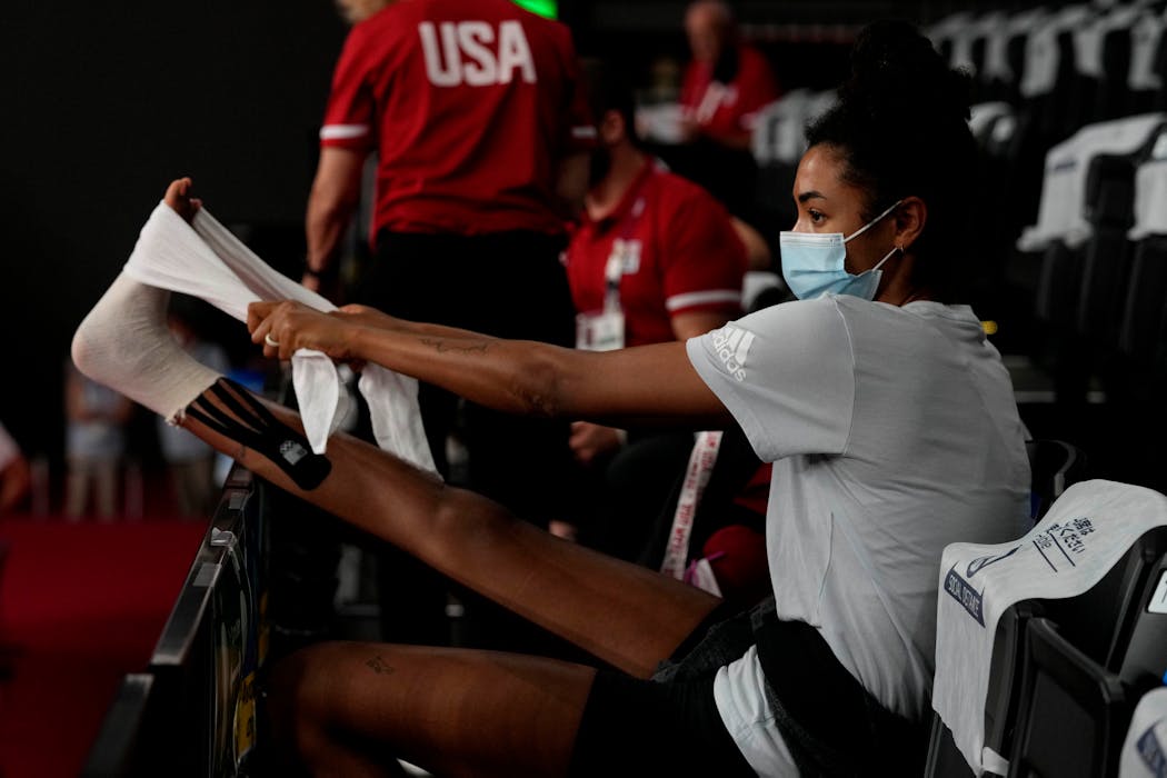 United States hitter Jordan Thompson of Edina treated her injured right ankle during the women’s volleyball match against Italy late Sunday.