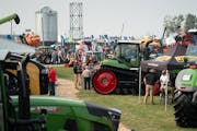 Folks gathered to talk and get a look at the equipment offerings at the Ziegler Ag Equipment display at Farmfest 2021.